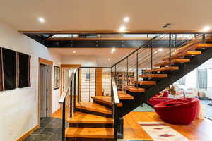 Stairs with visible vents, recessed lighting, and baseboards