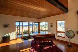 Dining space with a mountain view, plenty of natural light, baseboards, and wood finished floors
