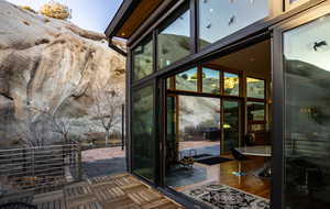 Doorway to outside with wood finished floors and expansive windows