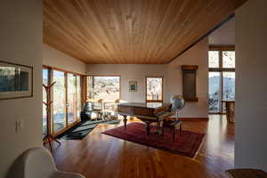 Home office with wooden ceiling and wood finished floors