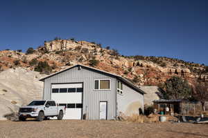 Detached garage with a mountain view and driveway
