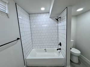 Full bathroom with baseboards, toilet, recessed lighting, shower / bathtub combination, and wood finished floors
