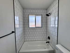 Full bathroom featuring shower / bath combination and toilet