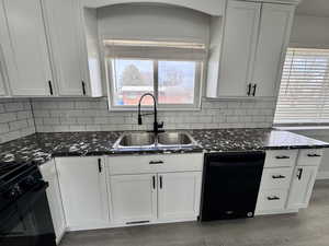 Kitchen with a sink, black dishwasher, a wealth of natural light, and gas range oven
