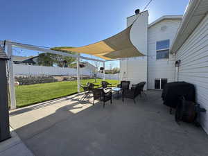 View of patio / terrace with a grill, fence, and an outdoor living space
