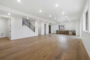 Unfurnished living room with light wood-type flooring and recessed lighting