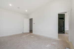 Spare room featuring lofted ceiling and recessed lighting