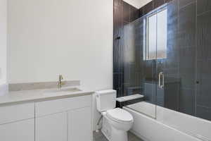 Full bathroom featuring vanity, combined bath / shower with glass door, and light tile patterned flooring