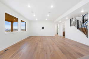 Unfurnished living room with light wood-style flooring and recessed lighting