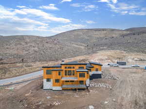 Aerial view of property and surrounding area featuring mountains