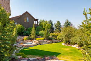 View of yard featuring an in ground hot tub