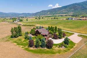 Birds eye view of property featuring a mountain view and a rural view