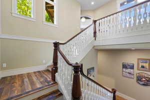 Staircase featuring recessed lighting, baseboards, and wood finished floors