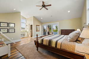 Bedroom with access to outside, wood finished floors, recessed lighting, french doors, and lofted ceiling