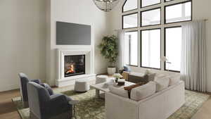 Rendering of Living area with a glass covered fireplace, light wood-style flooring, and a towering ceiling