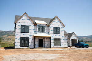 Property under construction featuring roof with shingles and a mountain view