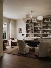 Living area with hardwood / wood-style floors and recessed lighting