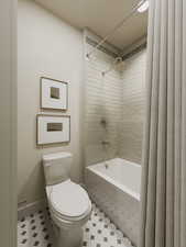 Bathroom with tile patterned floors and shower / bath combination with curtain