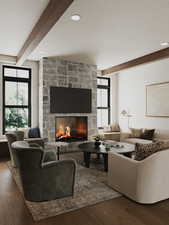 Living area with beam ceiling, wood finished floors, a stone fireplace, and a textured ceiling