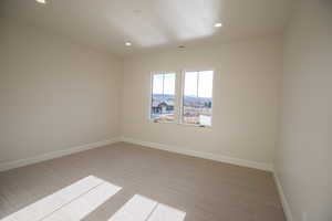 Carpeted spare room featuring recessed lighting and baseboards