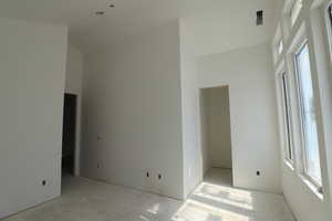 Unfurnished room with a high ceiling
