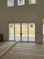 Doorway featuring a high ceiling and french doors