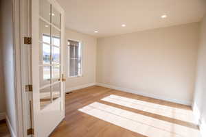 Unfurnished room with recessed lighting and light wood-style floors