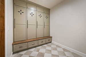 Mudroom with light floors and baseboards