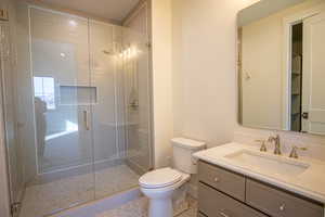 Full bathroom with vanity and a stall shower