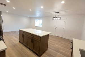 Kitchen with visible vents, recessed lighting, light countertops, and light wood-type flooring