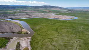 Aerial view of property's location with a water and mountain view