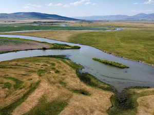 Aerial overview of property's location featuring a water and mountain view