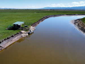 Overview of rural landscape featuring a water and mountain view