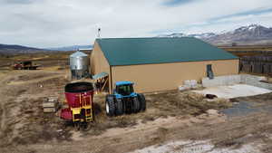 View of home's exterior with an outbuilding, a mountain view, and metal roof