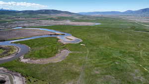 Aerial overview of property's location featuring a water and mountain view