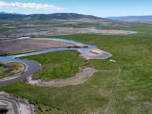 Aerial overview of property's location featuring a water and mountain view