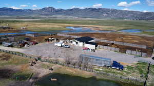 Aerial view of sparsely populated area with a water and mountain view