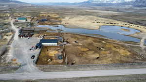 Drone / aerial view featuring a water and mountain view