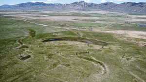 View of mountain backdrop with rural landscape