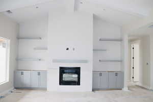 Unfurnished living room with baseboards and a glass covered fireplace