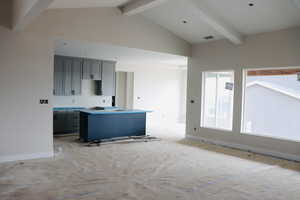 Living area with beam ceiling and high vaulted ceiling