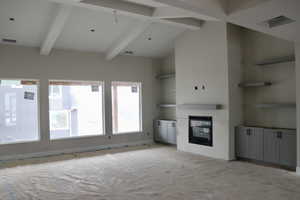 Unfurnished living room featuring high vaulted ceiling, a glass covered fireplace, and beam ceiling