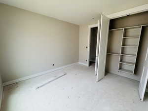 Unfurnished bedroom with a closet and baseboards