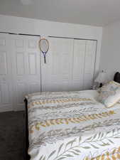 Carpeted bedroom with multiple closets