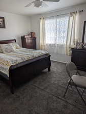 Bedroom with baseboards, ceiling fan, and carpet floors