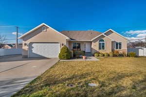 Ranch-style house with brick siding, a front lawn, fence, a garage, and driveway