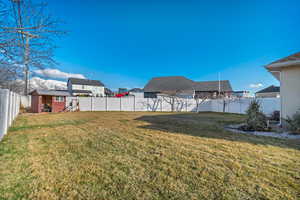 View of yard featuring a fenced backyard and an outdoor structure