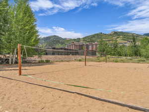 Surrounding community featuring volleyball court and a mountain view