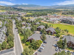 Aerial view of property's location featuring a mountainous background and nearby suburban area