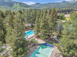 View of pool with a mountain view and a forest view